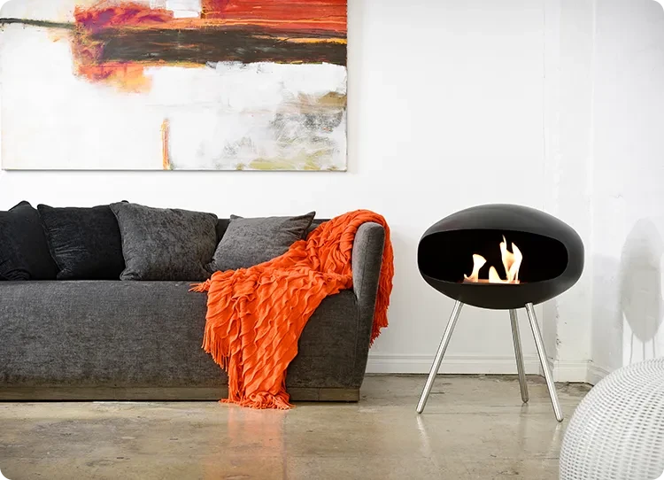 Cocoon terra bioethanol fireplace next to sofa