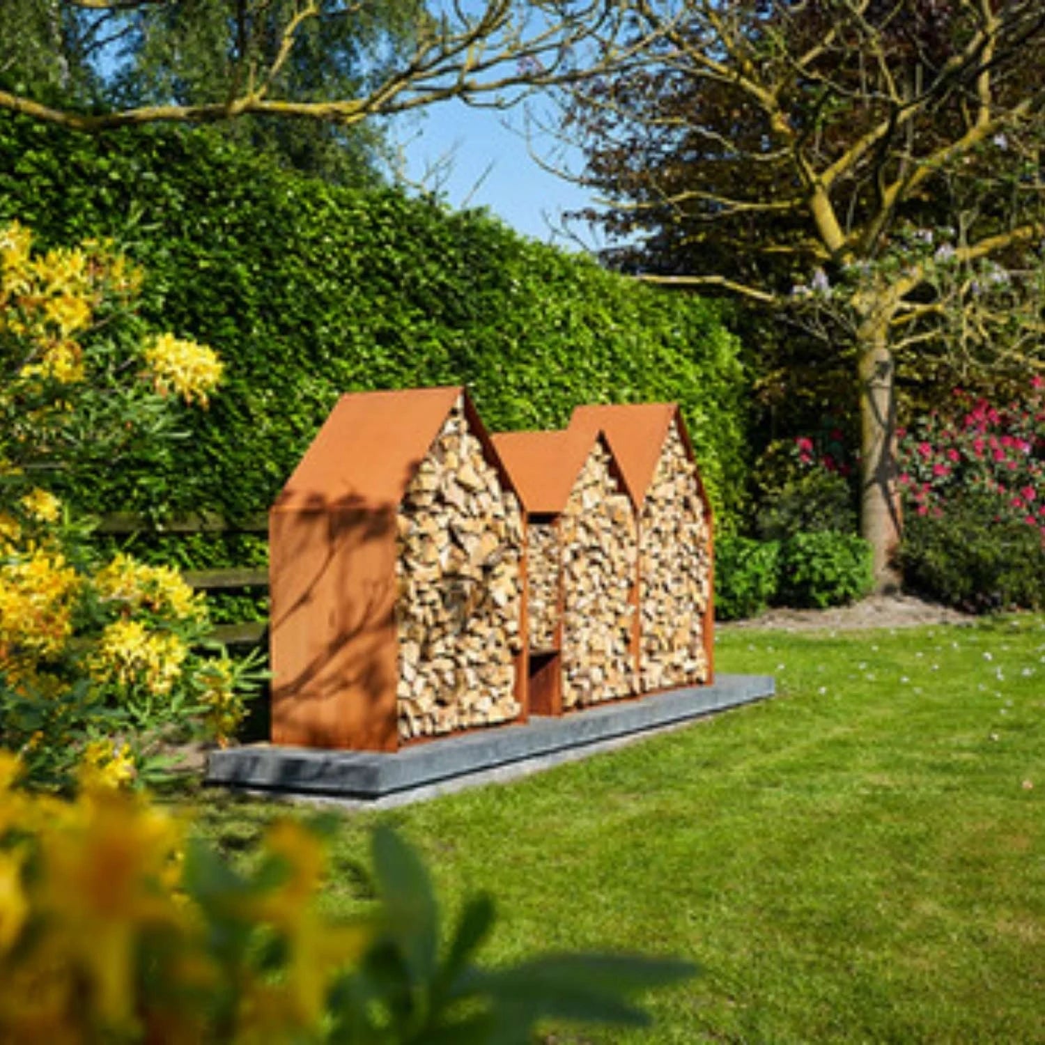 Bruges 3 Houses Log Storage, a spacious and durable solution for storing firewood in outdoor spaces like gardens and patios.